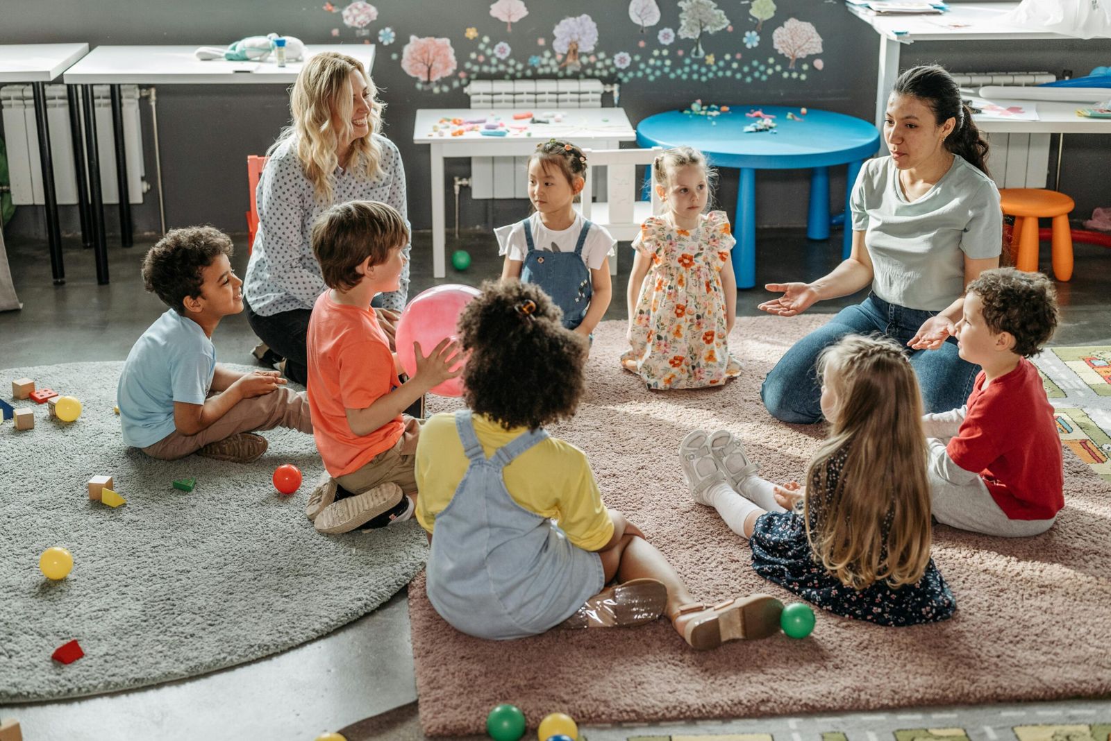 Childcare insurance for early learning centres: educators with children in a playroom